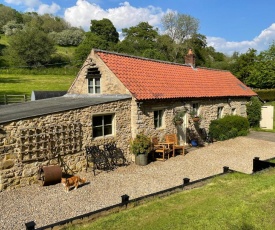 Mill Cottage with waterfall in North Yorkshire